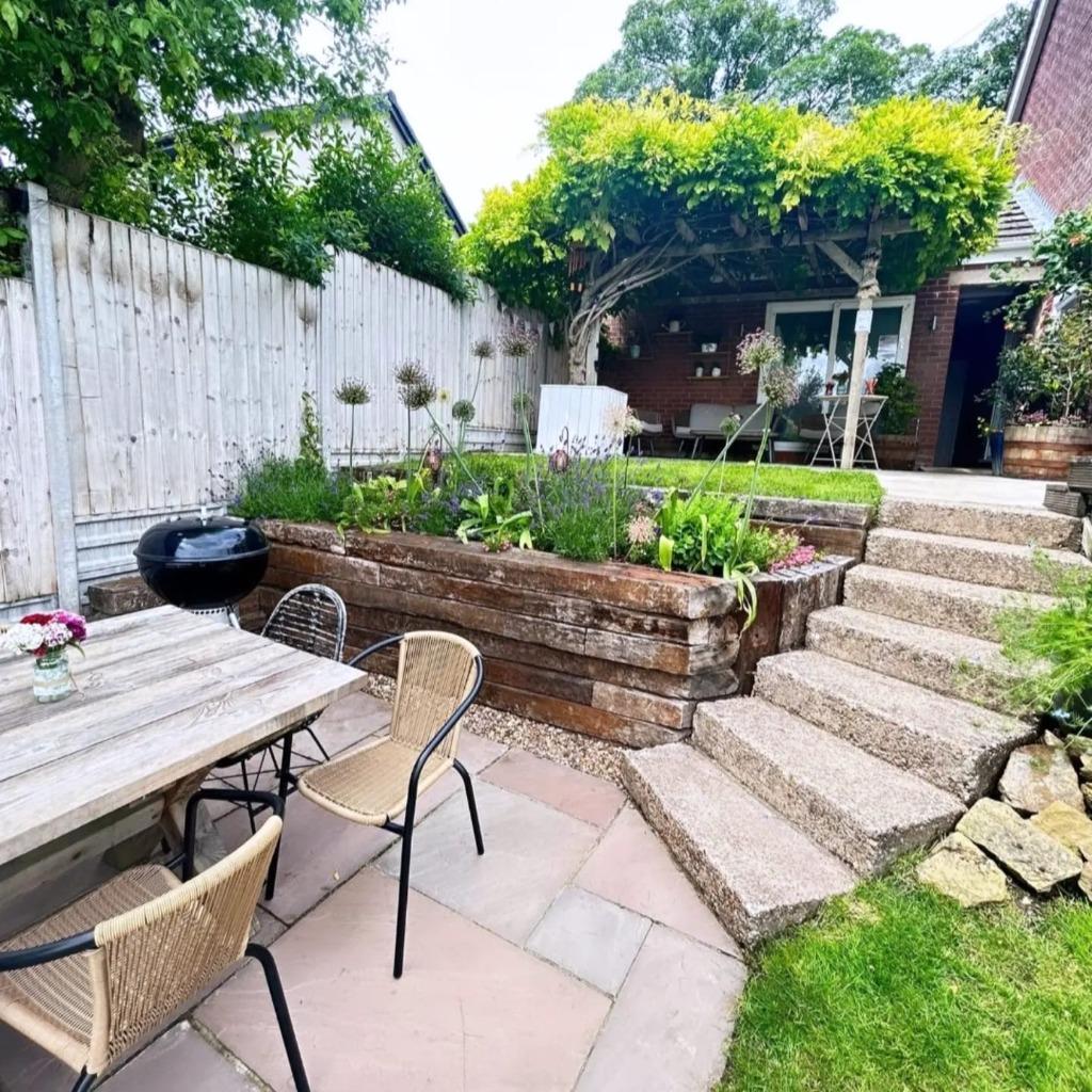 Finished garden terrace with surrounding planting